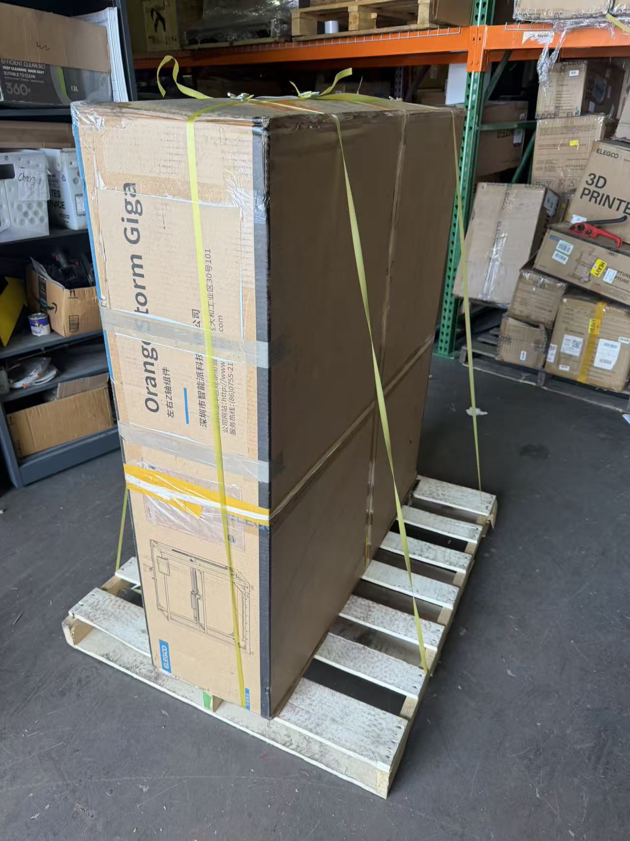 OrangeStorm Giga carton standing upright on a wood pallet and secured with yellow straps